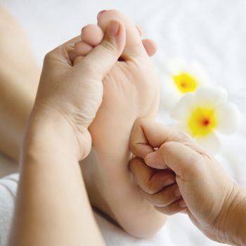 woman-receiving-foot-massage-service-from-masseuse-close-up-hand-foot-relax-foot-massage-therapy-service-concept