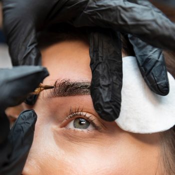 young-woman-getting-beauty-treatment-her-eyebrows